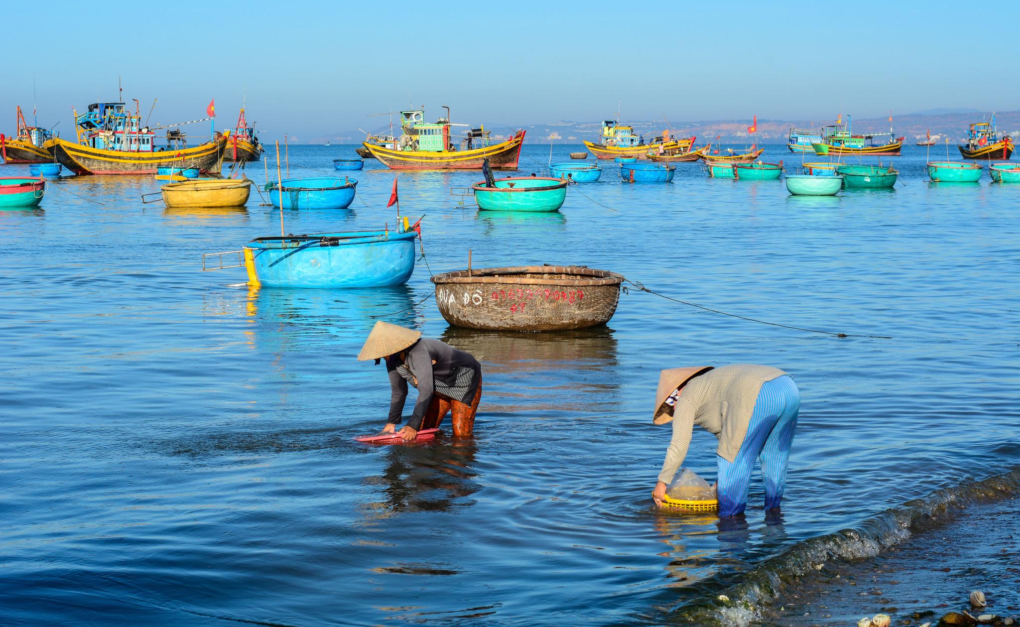 Women with traditional hats working at village by Phuong 