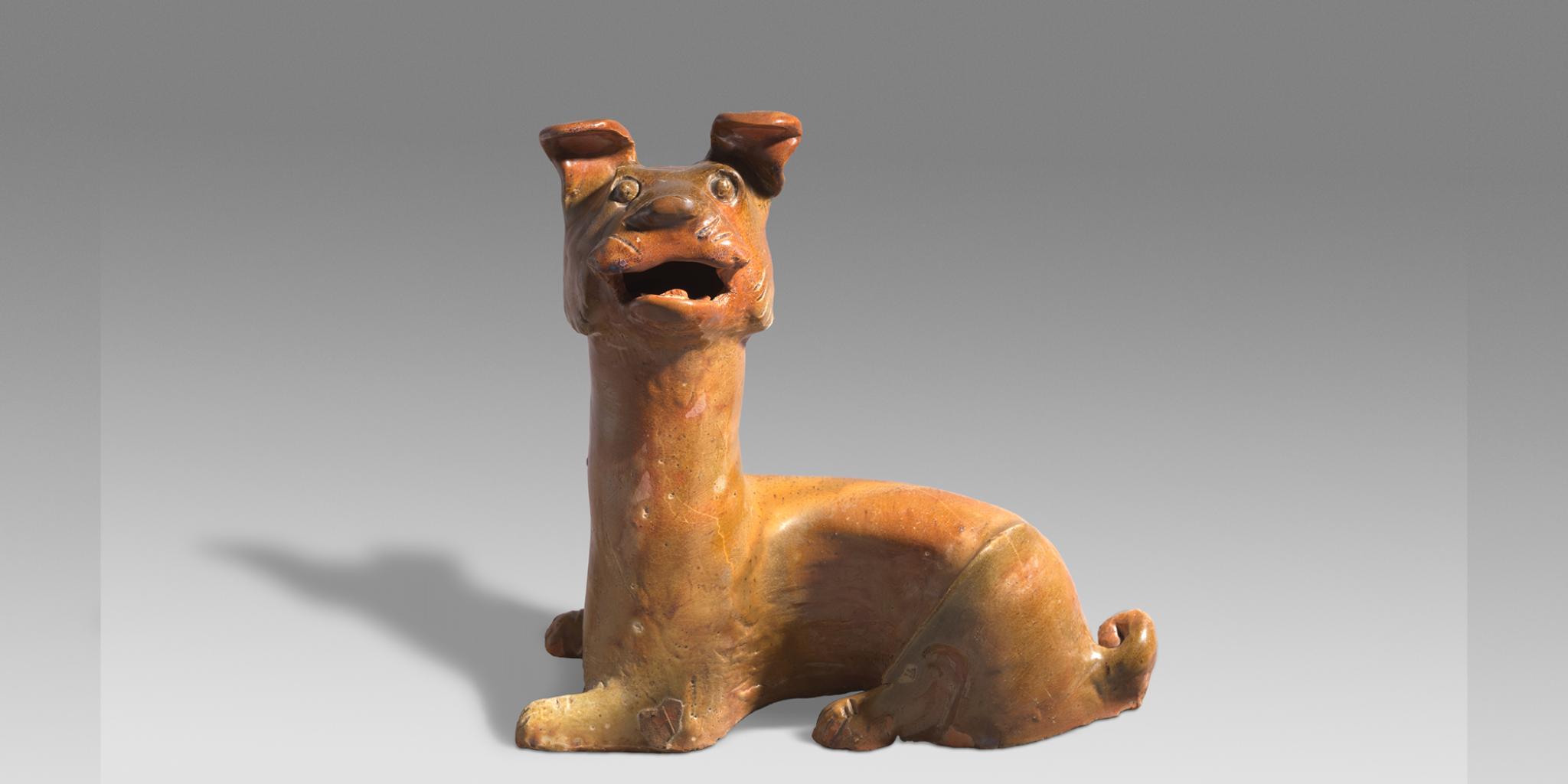 Reclining dog, Han dynasty, earthenware; glaze. Gift of TT Tsui, Hong Kong, through the National Gallery of Australian Foundation 1995. Image courtesy of the National Gallery of Australia.