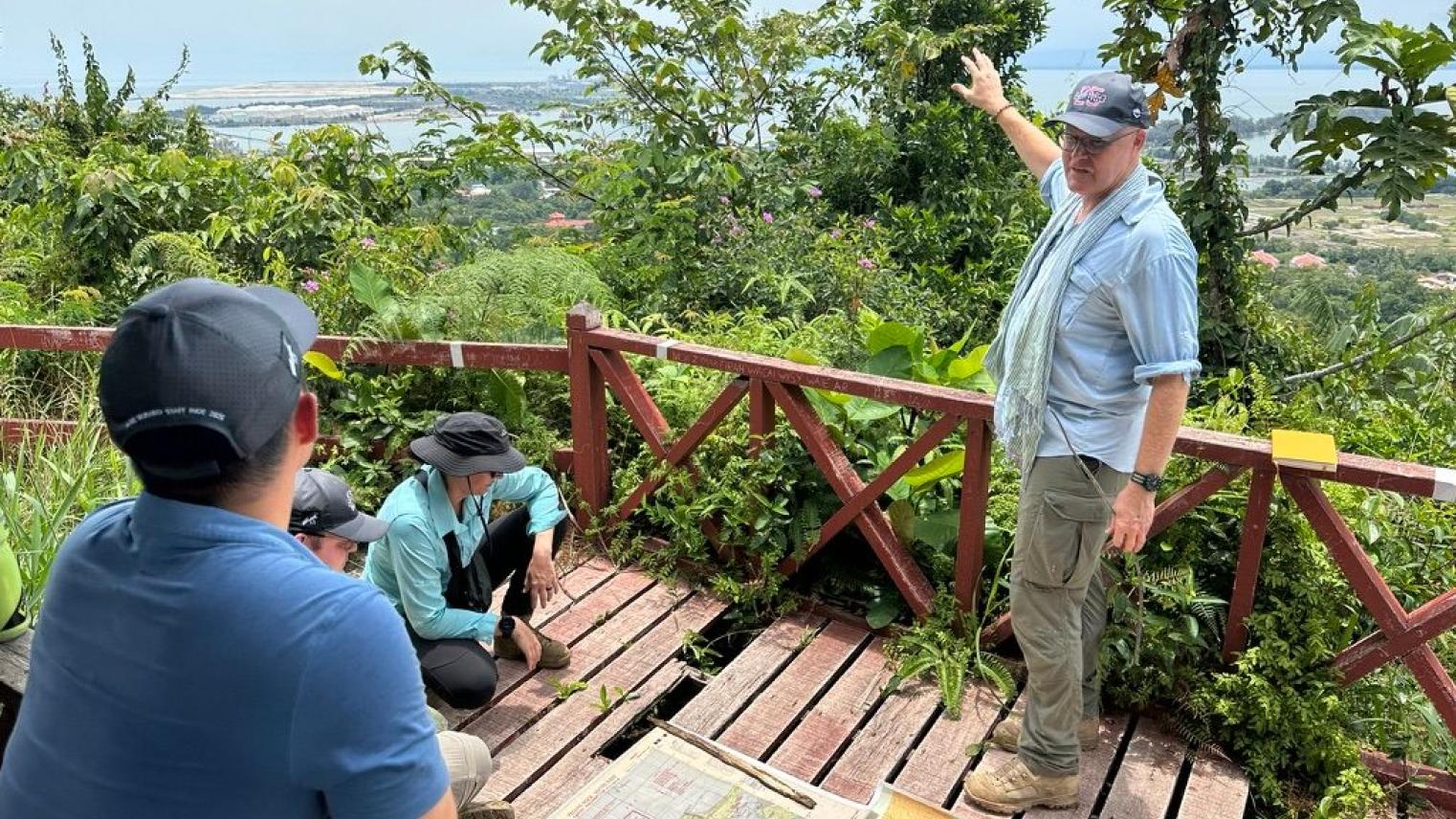 Associate Professor Garth Pratten discussing the strategic and operational significance of Brunei Bay to the Borneo campaign of 1945. The vantage point is the summit of Bukit Tempayan Pisang (722m), which was the site of a Japanese observation post prior to the Australian landings on 10 June 1945. Associate Professor Garth Pratten discussing the strategic and operational significance of Brunei Bay to the Borneo campaign of 1945. The vantage point is the summit of Bukit Tempayan Pisang (722m), which was the site of a Japanese observation post prior to the Australian landings on 10 June 1945.